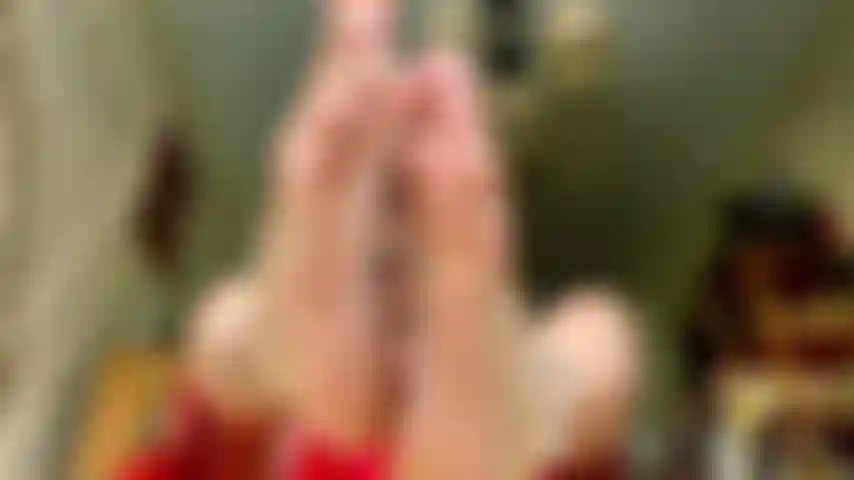 Ein rotes kleid mit abgesplitterten weißen nägeln.