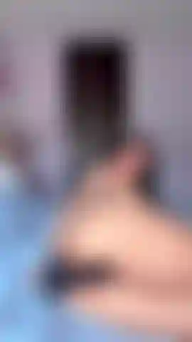 Playing with dildo in bed
