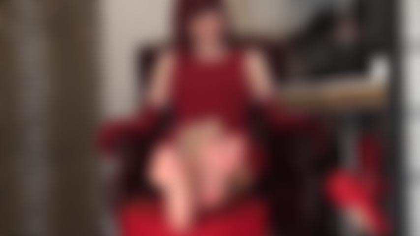 Lady in red teases the foot lover with her high arched sexy bare feet.
