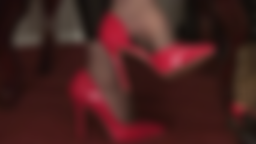 The power of red heels - Mistress Vivian is playing with your submissive mind, her wonderfully arched  pantyhose feet in elegant red low cut pumps.