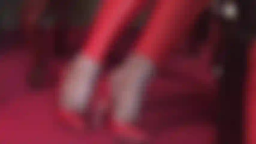 Strumpfhosen-fuß-teaser in roten lederpumps und passenden leggings.