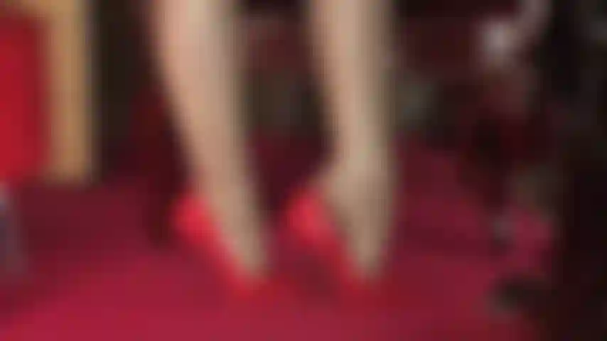 Die fußfetisch in unglaublich glänzenden nylonschichten und glänzend roten lackpumps pflegt.