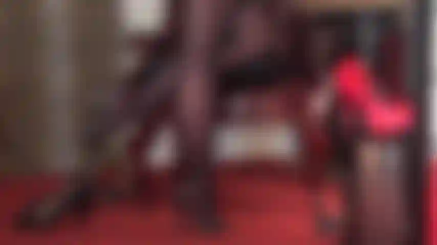 Die schuhe und füße in schwarzen hochhackigen lederpantoletten verehrt.