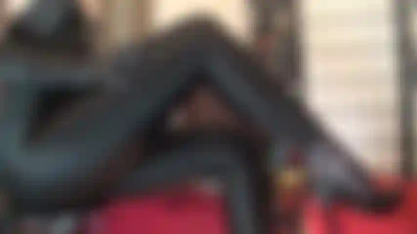 Beine in glänzenden schwarzen lycra-leggings, füße in schwarzen lederpumps und verstärkten strumpfhosen – bewundern sie die in glänzendes spandex gekleideten schenkel und beine der herrin und die nylonfüße in sexy stilettos.