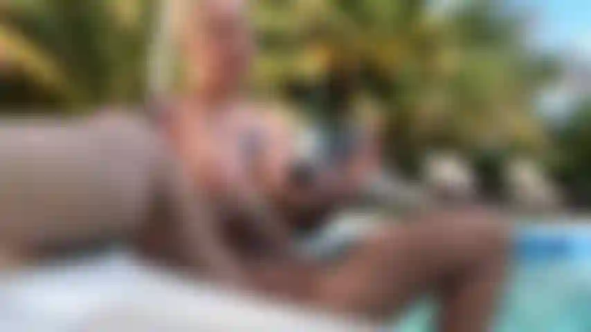 Naughty house-sitter Sam strips completely naked in her friend's backyard and spreads her pretty cunt wide on the pool steps. Watch this filthy MILF stuff her dripping pussy with a powerful vibrator right in the water, risking getting caught by neighbors at any moment. Her wet tits glisten in the sun as she teases her clit underwater, stifling her desperate screams while she works herself up. The water splashes violently as her body shakes, completely exposed and aching to cum in this risky outdoor solo scene. Will someone catch this slutty mama masturbating with her legs spread wide?