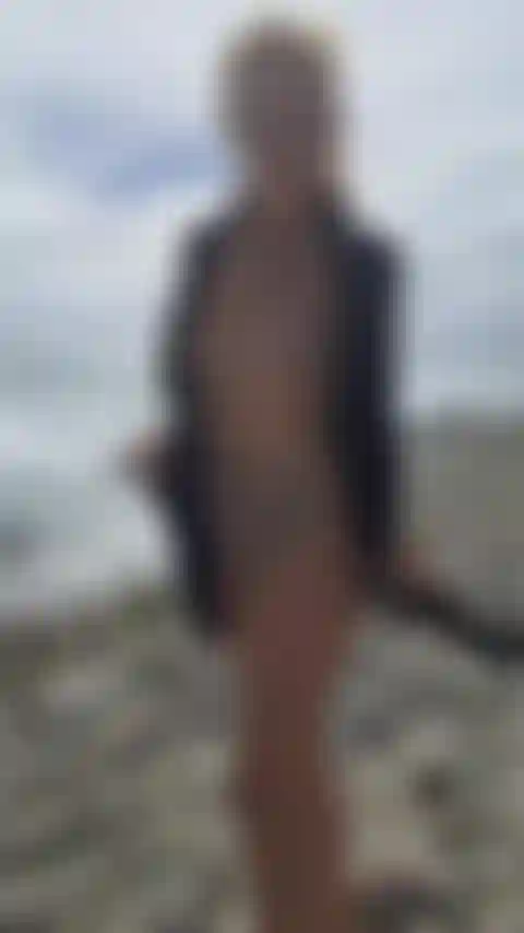 Am strand posiere ich nackt für die kamera.