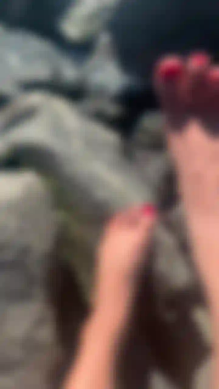 feet just playing on the rocks around the water, sexy red toes